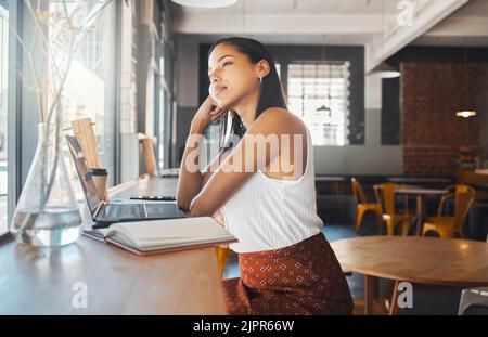 Thinking, idea and planning woman, writer or entrepreneur with a laptop and notebook dreaming of career growth, development and future plans Stock Photo