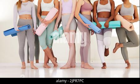 Health, fitness and yoga young women relax in pilates or exercise class studio for wellness. Group of zen friends waiting for chakra meditation or Stock Photo