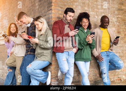 Multiracial friends group using smartphones to sharing content on social networks. Technology lifestyle concept - Selective focus Stock Photo