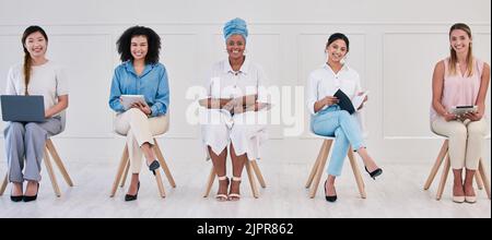Female corporate marketing or advertising planning team working in a creative agency for online website design company. Portrait of empowering women Stock Photo