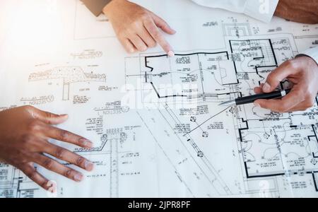Hands of architects, engineers and building construction workers planning project with blueprint in meeting at work, working on house and talking with Stock Photo