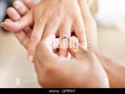 Closeup hand of proposal engagement ring after romantic, caring and loving man proposes to woman. Bonding, happy and in love couple getting engaged Stock Photo