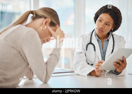 Supporting, consoling and comforting a patient with a doctor consulting a woman in the hospital during a medical appointment. Discussing negative test Stock Photo