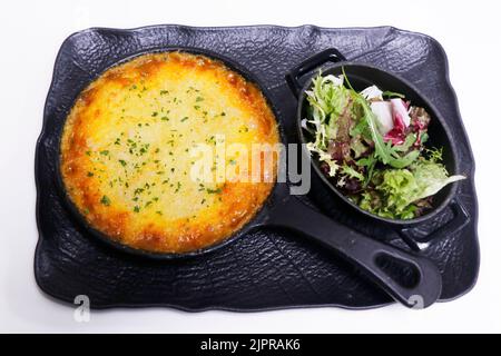 traditional english cottage pie with mixed leaves salad Stock Photo