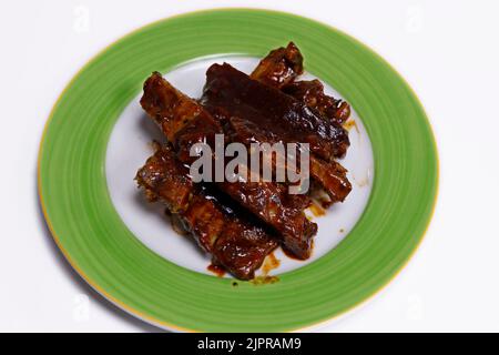 barbeque sauce glazed char grilled pork spare ribs in a plate Stock Photo