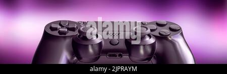 black video game controller isolated on a blurred lilac background - technology and video game concept Stock Photo