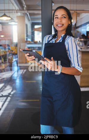 Startup, management and cafe owner online order on digital tablet doing inventory, happy and checking stock. Smiling woman enjoying her job, looking Stock Photo