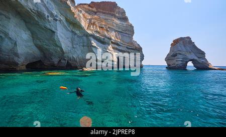 Divers in the water, rock gate in the water, pirate hideouts, caves, Kleftiko, tuff formations, sea turquoise, sea blue, sea green, caves, crystal Stock Photo