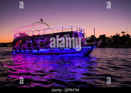Illuminated excursion boat on the Nile near Aswan, Egypt Stock Photo