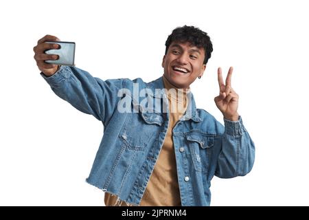Young peruvian man taking a selfie victory sign, isolated. Stock Photo