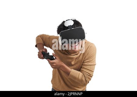 Young peruvian man playing games with joystick and vr headset, isolated. Stock Photo
