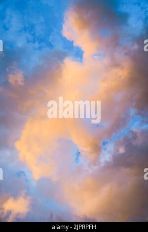 Pastel yellow, orange,pink, lilac, purple colorful clouds during sunrise twilight for background. Stock Photo