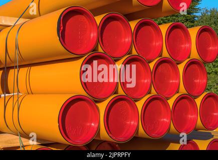 Pile of orange pvc protective pipes Stock Photo