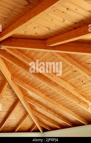 Attic gable ceiling. Wooden mansard construction. Traditional mediterranean house. Greek villa interior. Light blue white painted plaster wall and nat Stock Photo