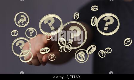 A man tapping the floating 3D rendered question mark icons Stock Photo