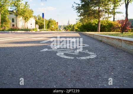 Cycling path in the park. Bicycle traffic sign painted on the floor. Concept of sport lifestyle. Stock Photo