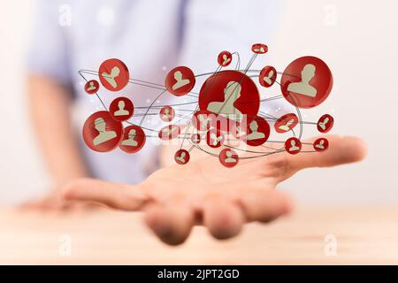 The 3d rendered profile icons hovering over a man's hand Stock Photo