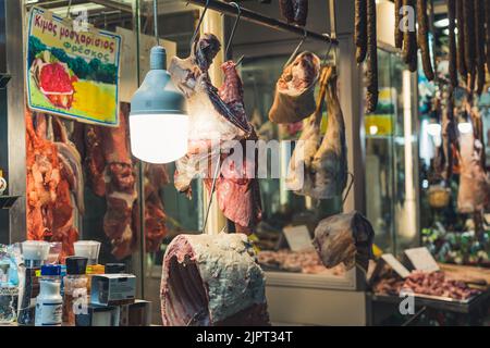 Local Kapani Market in Thessaloniki and its butcher's shop presenting various raw parts of animals and other meat to the customers. High quality photo Stock Photo