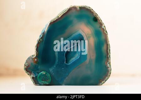 Large blue crystal of agate cross section isolated on white background. Natural translucent surface of agate crystal, blue abstract structural fragmen Stock Photo