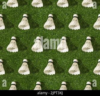 Seamless pattern of badminton shuttlecocks on green grass. Concept of sport lifestyle. Stock Photo