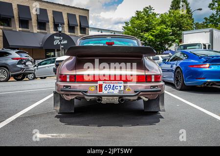 Rear view of a Porsche 911 Carrera S with doors open on a desert ...