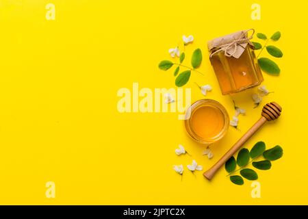 honey jar with acacia flowers and leaves. fresh honey top view flat lay. Stock Photo