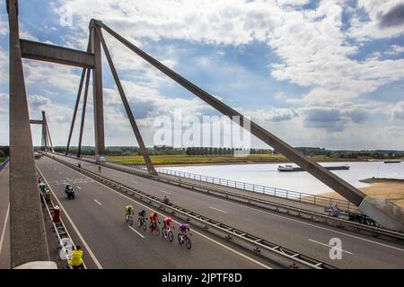 OOIJ - Atmosphere of the leading group with the peloton shortly behind that passes the Waal over the Prince Willem Alexander Bridge near Ooij during the second stage of the Tour of Spain (Vuelta a Espana). The second stage of the Vuelta goes from Den Bosch to Utrecht. ANP VINCENT JANNINK Stock Photo