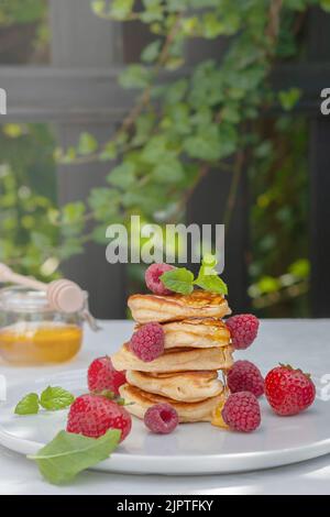 Pancakes with wild berries on the table. Healthy breakfast. Stock Photo