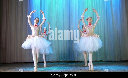ballet rehearsal, on the stage of the old theater hall. Young ballerinas in elegant dresses and pointe shoes, dance elegantly certain ballet motions, pass, scenic bow. High quality photo Stock Photo