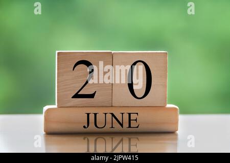 June 20 calendar date text on wooden blocks with blurred nature background. Copy space and calendar concept. Stock Photo