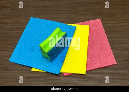 Kitchen colorful sponge cleaning tools and utensils on wood table used in households Stock Photo
