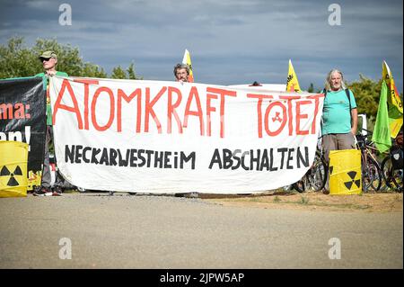 Neckarwestheim, Germany. 20th Aug, 2022. Anti-nuclear activists demonstrate near the nuclear power plant. The demonstration takes place as part of a three-week continuous protest, an anti-nuclear bike tour through southern Germany, Switzerland and France. This is to demonstrate for the shutdown of all nuclear power plants. Credit: Ferdinando Iannone/dpa/Alamy Live News Stock Photo