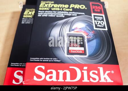 A closeup of Sandisk brand SD memory cards in black packaging for sale on a table Stock Photo