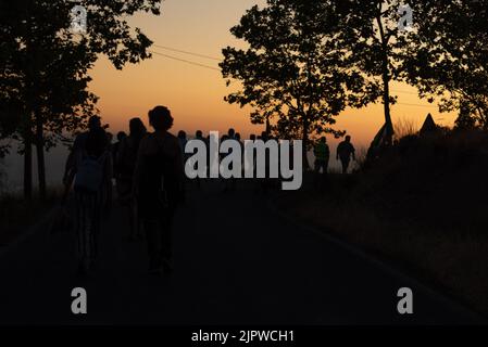 Group of silhouettes at sunset of people walking along the road from Viznar to Alfacar on the occasion of the popular march in tribute to Federico Gar Stock Photo