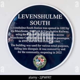 A plaque within the restored Levenshulme South station, now a cycle café and bar in Manchester, England, UK Stock Photo