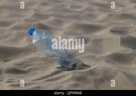 Bottle of water drink on a sandy beach. Stock Photo