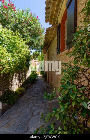 Picturesque old alley in the village of Bormes-les-Mimosas, France, in the French department of Var, in the Provence-Alpes-Côte-d'Azur region Stock Photo