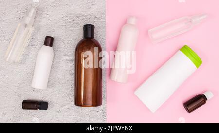 Bottles of Beauty and cosmetics products on white and pink background. Flat lay Stock Photo