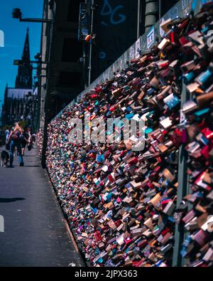 A vertical shot of love locks on Hohenzollern bridge in Cologne, Germany Stock Photo