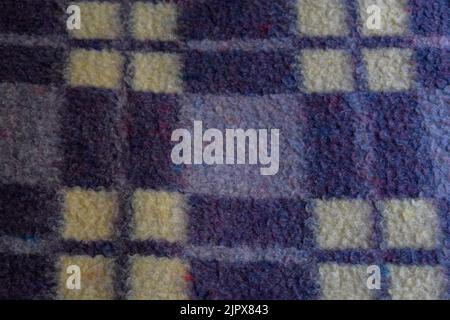 Purple and yellow checkered wool blanket texture background Stock Photo