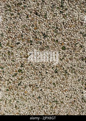 close-up of a wall covered with small stones Stock Photo