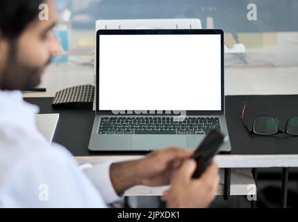 Business man working with mock up laptop white screen on background. Stock Photo