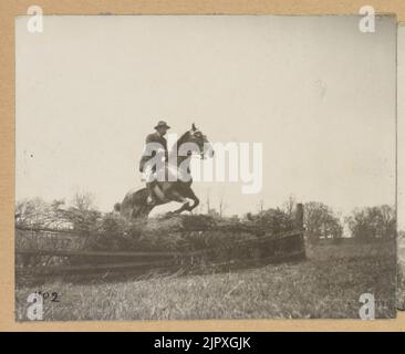 Theodore Roosevelt, on horseback, jumping fence Stock Photo