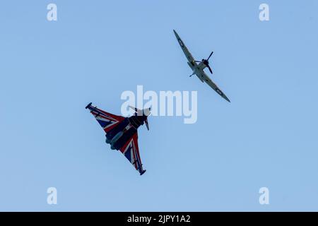 Eastbourne, East Sussex, UK.. 20th Aug, 2022. Featuring the RAF Typhoon, Blackjack, display team in tandem with a  at the Battle of Britain Spitfire at the annual Eastbourne Airshow viewed from the beach at Eastbourne. 20th August 2022. Credit David Smith/Alamy Live News Credit: David Smith/Alamy Live News Stock Photo