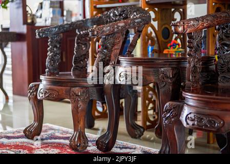 A set of beautifully carved luxury mahogany tables and chairs Stock Photo
