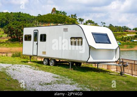 An RV parked on the lawn outdoors Stock Photo