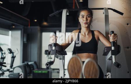 Sporty woman performing abdominal crunches training practicing in gym. Stock Photo
