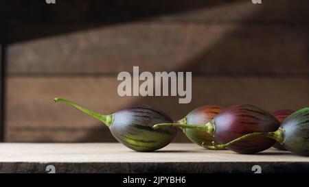 tamarillo or tree tomatoes on a wooden surface, an egg-shaped edible fruits, taken in natural lighting with copy space Stock Photo