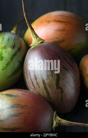 close-up of tamarillo or tree tomatoes, pile of an egg-shaped edible fruits, macro view in soft-focus background Stock Photo