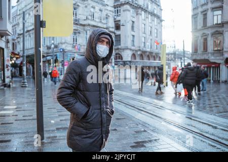 man wearing face mask waiting for the tram Stock Photo